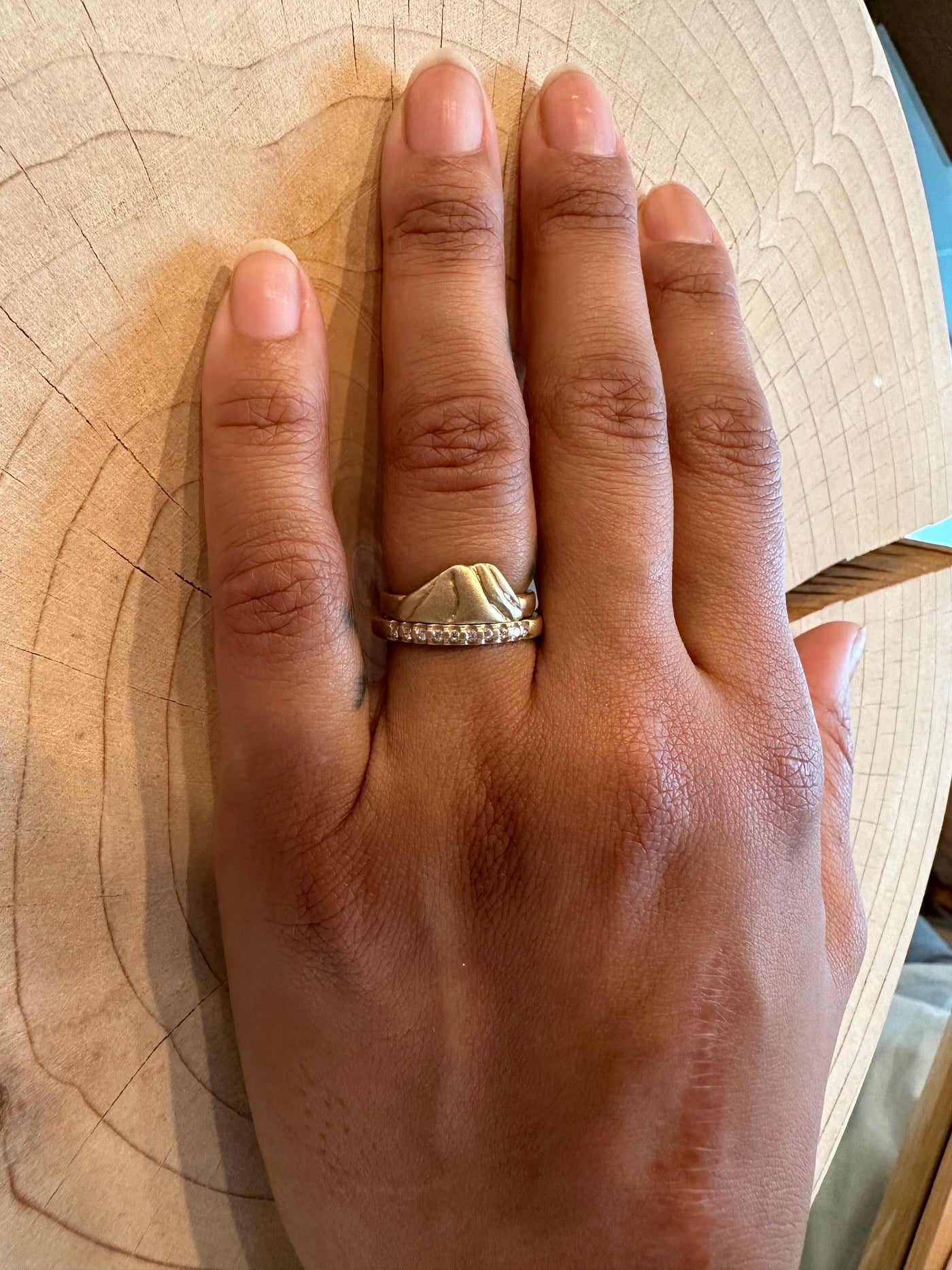 Yellow Gold Mt. Rainier Ring on hand with Passageways Infinity Band